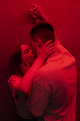 Zwei Singles küssen sich im Rotlicht