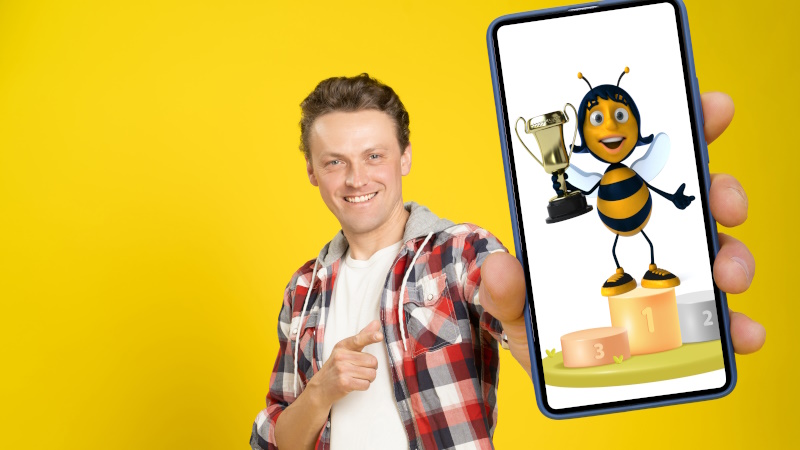 Mann zeigt Handy mit Gewinner-Biene im Display