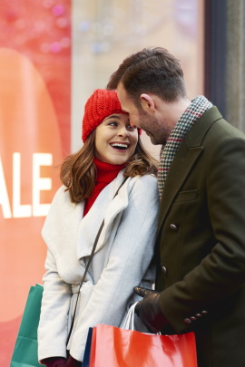 Mann und Frau flirten in der Einkaufsstraße